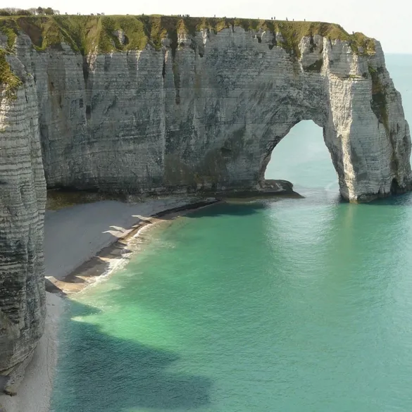 A striking rock formation featuring a large arch, located along the scenic French coastline.